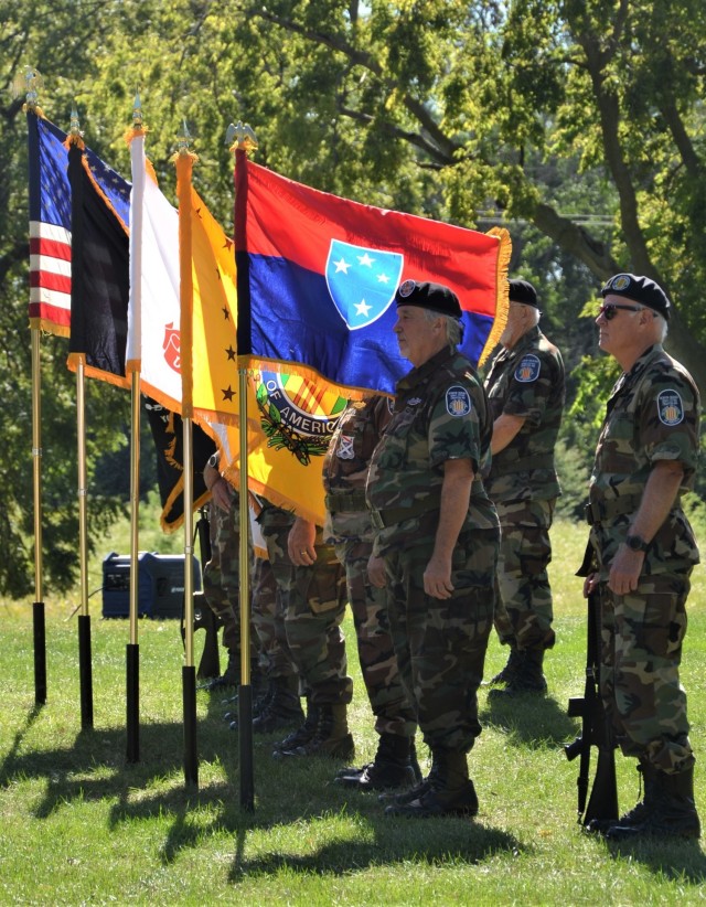 The Color Guard stand proudly during the closing prayer as the Americal Division colors wave in the breeze at the Americal Division Memorial ceremony at Rock Island National Cemetery in Illinois. Photo by: Staci-Jill Burnley, ASC Public Affairs