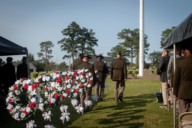 U.S. Army Training Center and Fort Jackson Commander Brig. Gen. Patrick R. Michaelis, right, Command Sgt. Major Philson Tavernier, left, and a wreath bearer place a red, white and blue wreath at the base of the Fort Jackson flagpole in Centennial Park to honor every American who made the ultimate sacrifice on 9/11 and the past 20 years of conflict. Seven wreaths were placed at the flagpole during a wreath laying and remembrance ceremony on Sept. 10, 2021.