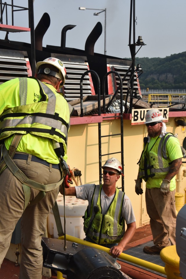 Scott Rolbiecki and Nick Stanton, maintenance and repair, work on the miter gate replacement at Lock and Dam 2, near Hastings, Minnesota, July 20.