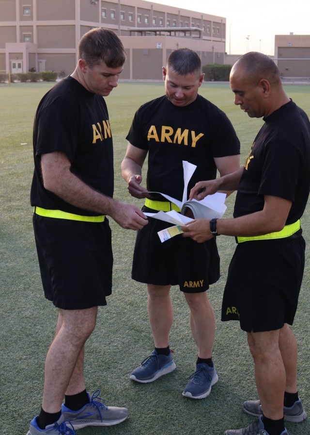 Master Sgt. Charles York (center), the aide to 1st Theater Sustainment Command's Command Sgt. Maj. Michael J. Perry III, along with Sgt. 1st Class Jordan Cagle (left), an executive administrative assistant to U.S. Army Central Command's Command Sgt. Maj. Brian A. Hester, and Master Sgt. Javier Garciabaez, the noncommissioned officer-in-charge of the plans section at 1st TSC's operational command post, tabulates the final team scores at the end of a Sept. 12, 2021, physical fitness round-robin based on the Army Combat Fitness Test, where 37 sergeants major, including Hester and Perry competed in six teams. York, who was the NCOIC for the event said it was a great way to bring the most senior enlisted leaders from different units together. "We are a team of teams."