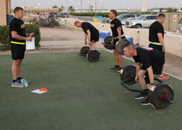 U.S. Army Central Command's Command Sgt. Maj. Brian A. Hester (right) deadlifts during a Sept.12, 2021, physical fitness round-robin based on the Army Physical Fitness Test he led with 36 other sergeants major from across Camp Arifjan, Kuwait. The event had the sergeants major broken up into six teams, who competed for bragging rights, followed by a police call of the field the area around the camp's Zone 1 post exchange.