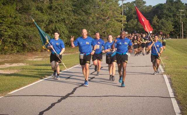 U.S. Army Training Center and Fort Jackson Commander Brig. Gen. Patrick R. Michaelis, left, and Command Sgt. Maj. Philson Tavernier, right, lead more than 500 Soldiers and trainees to the finish line of the 2021 5K Run/Walk for the Fallen. The annual event held at Hilton Field fell on the 20th anniversary of 9/11.