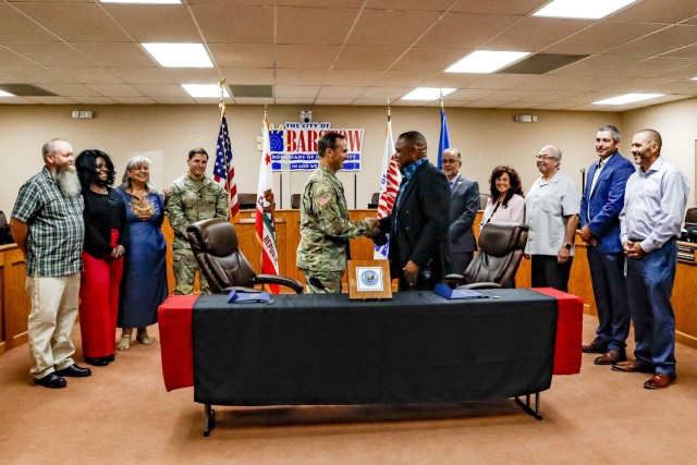 Fort Irwin Garrison Commander, Col. Jason Clarke, and Barstow City Mayor, Paul Courtney shake hands after IGSA signing.