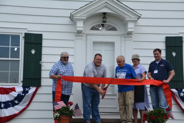 Jim Rand, chief of locks and dams, cuts the ribbon at the lockmaster house in Guttenberg, Iowa, June 6.