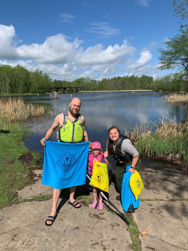 Megan Severson, park ranger, hands out a towel to a visitor wearing a life jacket at Pokegama Recreation Area, near Grand Rapids, Minnesota, May 21.