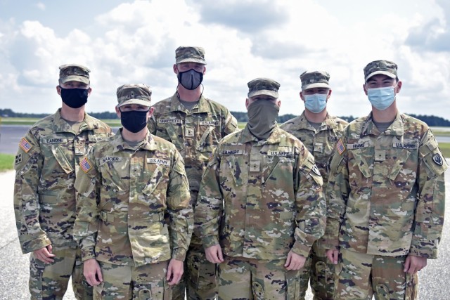 The first six Army aviation flight school students to solo in the UH-72 Lakota gather just prior to their solo flights on Sept. 11, 2021, at Fort Rucker, Alabama.   From left: Warrant Officer Eanone Travis, Warrant Officer Saucier Tanner, Warrant Officer Shaffer Dalton, Warrant Officer Greg Lambert, 2nd Lt. Connor Regan, and Warrant Officer Nicholas Franke.