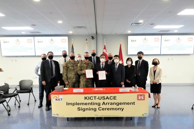 Brig. Gen. Kirk Gibbs, U.S. Army Corps of Engineers Pacific Ocean Division commander; Dr. Kim Byung-suk, Korea Institute of Civil Engineering and Building Technology president, hold the signed Implementing Arrangement, while posing for a photo with senior leaders from the KICT and the Far East District, Aug. 27. (U.S. Army Photo by O Sang-sung)