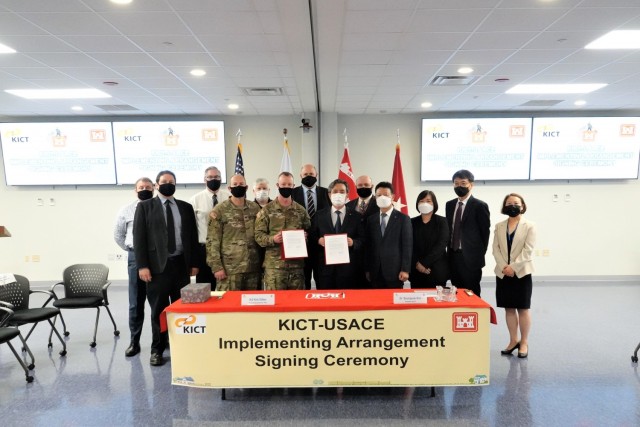Brig. Gen. Kirk Gibbs, U.S. Army Corps of Engineers Pacific Ocean Division commander; Dr. Kim Byung-suk, Korea Institute of Civil Engineering and Building Technology president, hold the signed Implementing Arrangement, while posing for a photo...