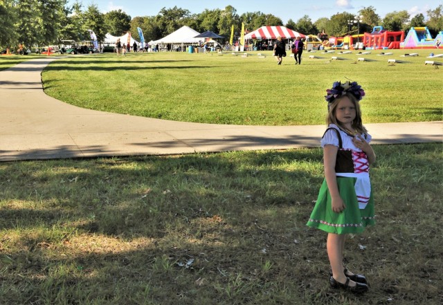 A girl dressed in traditional German attire stands overlooking Brooks Field where the annual Fort Knox Oktoberfest celebration took place Sept. 17, 2021.