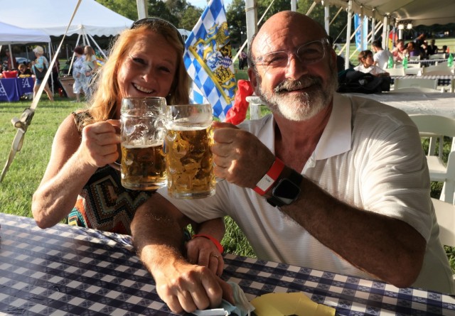 A couple toasts their steins of German beer at the annual Fort Knox Oktoberfest celebration Sept. 17, 2021, on Brooks Field.