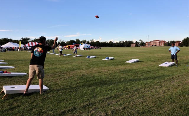 Participants toss bean bags during the cornhole tournament on Brooks Field at the annual Fort Knox Oktoberfest celebration Sept. 17, 2021. Cash prizes were awarded to the winners.