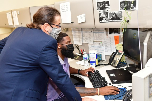 Recent graduate, Brandon Harvey, receives training on Defense Transportation Tracking System softwar