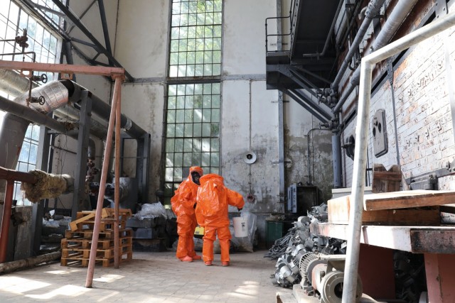 U.S. Army Reserve Soldiers with the 773rd Civil Support Team, 7th Mission Support Command, based out of Kaiserslautern, Germany, scan the inside of an abandoned building to identify chemical threats during a training scenario mission held at...