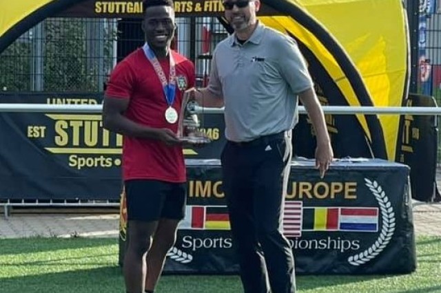 Shane Rose accepts the trophy for tournament MVP from Aaron Jones, IMCOM-Europe Community Recreation, Sept. 18 at the conclusion of the unit-level soccer championships held at USAG Stuttgart.