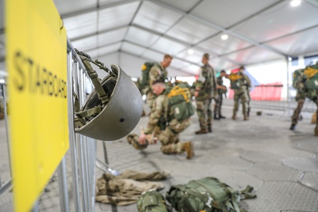 Soldiers from 12 NATO nations await for their flight at the Departure Air Field Sept. 15, 2021 at Eindhoven Air Force Base, Netherlands. During this phase of the exercise Soldiers dawn their parachute rigs and inspect each other to ensure their...