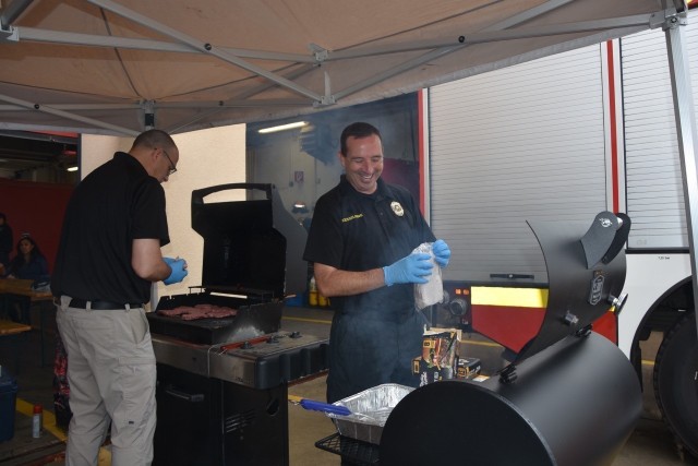 Rick Dutkiewicz, Deputy Director of Emergency Services, and Jason Kesselring, Garrison Chief of Police, work the grills for the DES annual cookout Sept. 15.