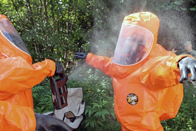 U.S. Army Reserve Sgt. 1st Class Saugat Cope, left, reconnaissance noncommissioned officer-in-charge for the 773rd Civil Support Team, 7th Mission Support Command, based out of Kaiserslautern, Germany, decontaminates 773rd operations NCO, Sgt. 1st...