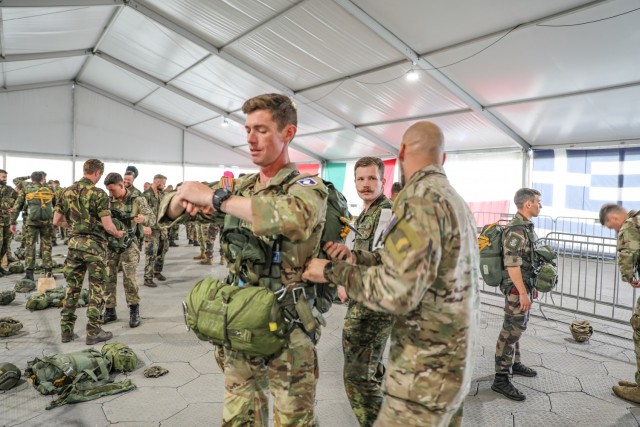 Sgt. 1st Class Jonathan Andersen (left), S-3 Air Operations, 1st Battalion (Airborne), 143rd Infantry Regiment, receives a pre-flight inspection of his German parachute from a German Soldier during Falcon Leap, Sept.15, 2021, at Eindhoven Air Base...