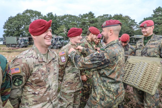 Spc. Dustin Dunlap, 294th Quartermaster Company, 372nd Combat Sustainment Support Battalion, receives his German Airborne wings during the post jump award ceremony during Falcon Leap Sept. 15, 2021, at Ginkelse Heide drop zone in the Netherlands....