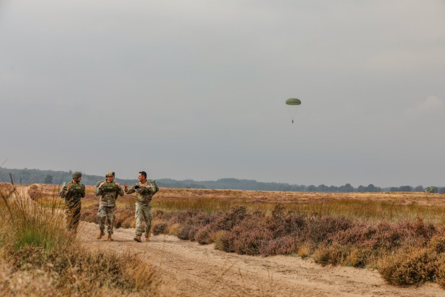 Sgt. 1st Class Jared Zuniga, first sergeant for the 294th Quartermaster Company, 372nd Combat Sustainment Support Battalion walks away from the Ginkelse Heide drop zone after jumping with a U.S. and Royal Netherlands Army Soldier during Falcon...
