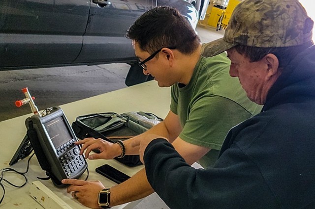 Joe Martinek, Federal Aviation Administration Instrument Landing System instructor trains FAA technician Bryan Cardona as part of FAA ILS training in a maintenance hangar at Fort Greely’s Allen Army Airfield in interior Alaska from July 14 to Aug. 24, 2021. (Photo by Brian Fraiser)