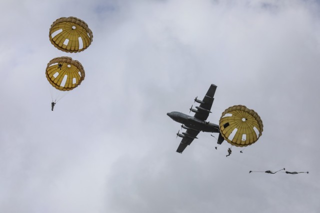 Soldiers from 12 NATO allied nations parachute from a C-130, Sept. 15, 2021, at Houtdorperveld drop zone in the Netherlands. The exercise includes more than 1,000 paratroopers from all over the world, 12 different nationalities, multiple airdrops...