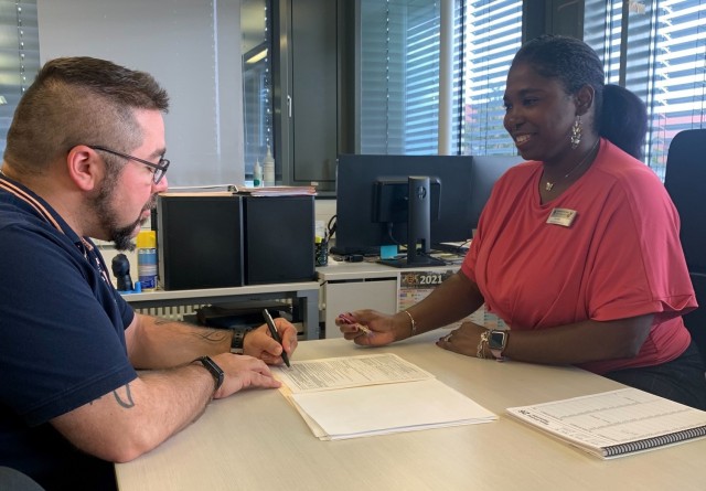 Jenn Page, a transportation counselor with the 405th Army Field Support Brigade’s Logistics Readiness Center-Stuttgart, discusses how to properly assist customers with their outbound shipping documents with one of her coworkers at the...
