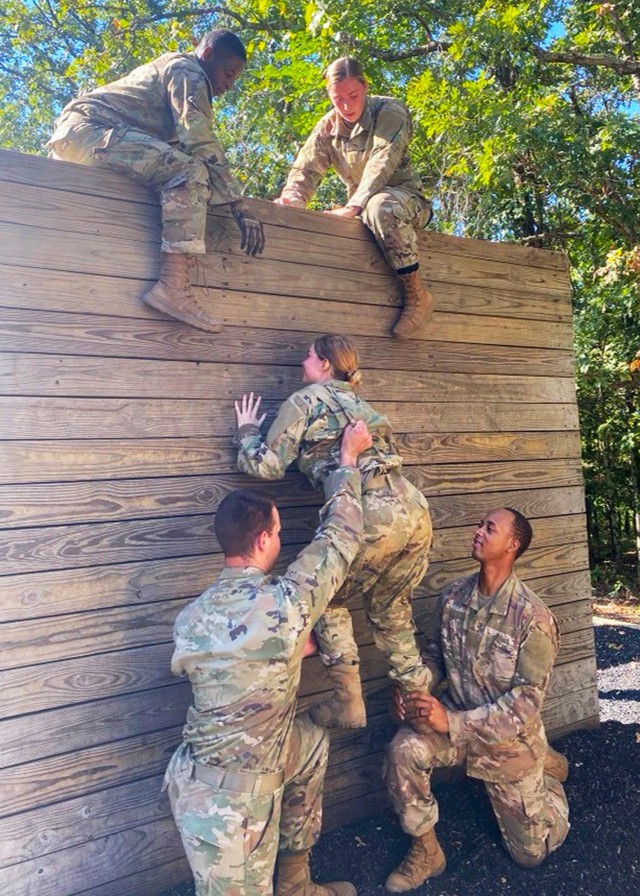 Cadet Brooke Payne works with her team to complete the confidence course Sept. 18 at Training Area 97, as part of the Army ROTC Gateway Battalion’s fall FTX.