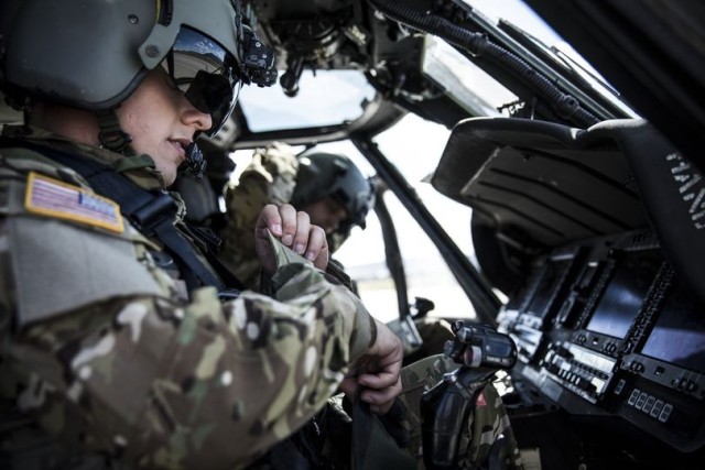 Army Black Hawk pilots prepare for flight.