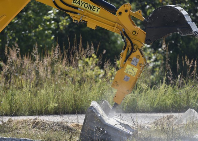 Cpl. Ryan Emerson, a horizontal construction engineer from the 41st Clearance Company at Fort Riley, Kansas, assesses the capabilities of the Bayonet Breaker, an attachment that can be installed on existing equipment that allows one vehicle to...