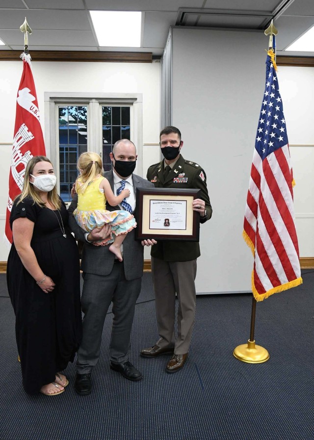 LDP II graduate Allen Malcomb is joined by his wife and daughter as he accepts his certificate of completion for  the year long leadership program.