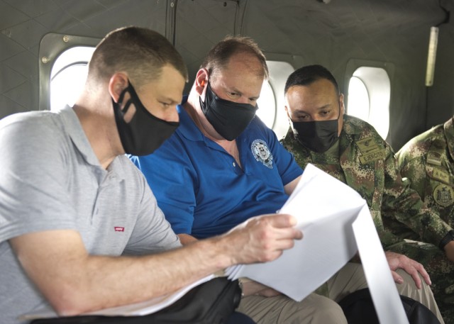 Joe Kidwell, left, the Colombian country case manager at U.S. Army Security Assistance Command – New Cumberland, along with Jason King, center, the USASAC Colombian country program manager, and their Colombian military counterpart, discuss foreign military sales cases during flight to see the Tolemaida Air Base, 6 April 2021. Kidwell, King and other members of the USASAC command leadership, visited several sites to see the impact of U.S. security assistance and foreign military sales, in support of the Colombian military in defending their country from counter-narcotic and terrorist threats. (U.S. Army photo by Richard Bumgardner)