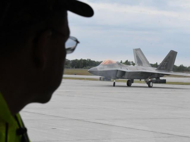 Ed Chiasson, Wheeler-Sack Army Airfield operations officer, watches as an F-22 Raptor from Joint Base Langley-Eustis, Virginia, lands for a hot refueling operation Sept. 21. (Photo by Mike Strasser, Fort Drum Garrison Public Affairs)