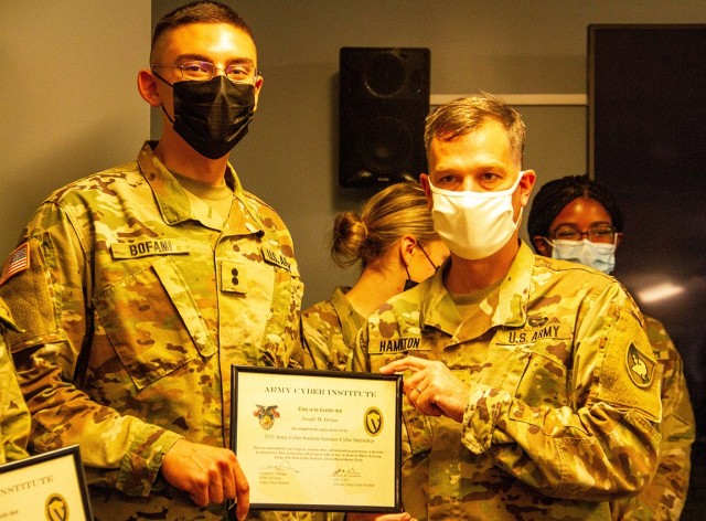 Reserve Officersʼ Training Corps Class of 2022 Cadet Joseph Bofani (left) receives a certificate from Col. Stephen Hamilton (right), an assistant professor at the Department of Electrical Engineering and Computer Science, after completing an...
