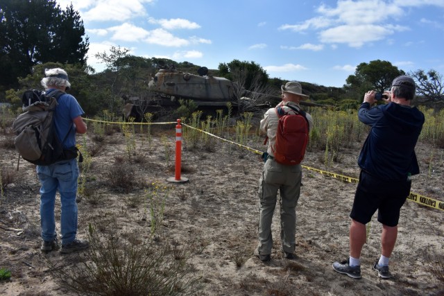 Hikers take photos of a M58 Tank, part of the “Patton” family line of armor, during a guided nature walk inside the Fort Ord Impact Area, Fort Ord National Monument, Calif., Sept. 18.