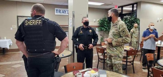 From left, Eric Coffman, Geary County Sheriff, and Capt. Justin Stopper, Geary County Special Operations, talk with Col. William B. McKannay, Commander of U.S. Army Garrison Fort Riley, at the inaugural law enforcement breakfast at Fort Riley, Kansas, Sept. 2.