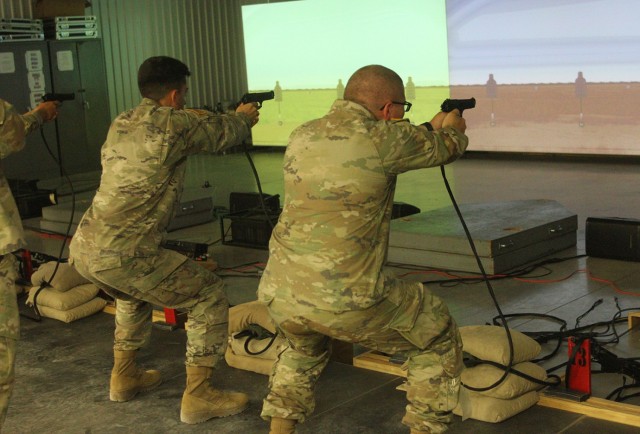 Soldiers fire from the squatting position Sept. 15, 2021, in the Engagement Skill Trainer-1 at Fort Sill, Oklahoma. The Soldiers were in training to serve as security guards augmenting Directorate of Emergency Services personnel. 