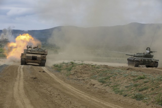 A U.S. Army M1A2 Abrams tank fires upon its target alongside a Bulgarian Armed Forces T-72 main battle tank during a live-fire exercise in support of Saber Guardian at Novo Selo Training Range in Bulgaria, May 30, 2021. The U.S. Army Corps of...