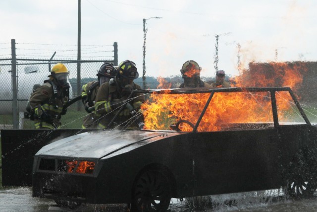 Firefighters from the Clarksville-Montgomery County community work together to extinguish a car fire during Fire Fighter I and Fire Fighter II live fire practical evaluations, hosted Sept. 16 at Fort Campbell Fire and Emergency Services’ training facility. Fort Campbell Fire and Emergency Services helped 13 firefighters from the Clarksville-Montgomery County area take the next steps in their careers with Fire Fighter I/II live fire practical evaluations. The state of Tennessee requires firefighters to progress in their training, Without the Fort Campbell partnership, achieving these certifications would be logistically difficult, said Kevin Falsetto, fire training officer, Montgomery County Fire Department.