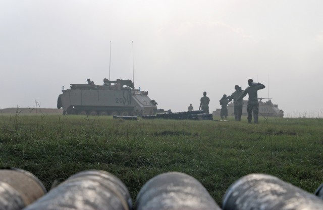 Soldiers assigned to the mortar section of 3rd Battalion, 67th Armored Regiment, 2nd Armored Brigade Combat Team, 3rd Infantry Division, carry 120mm training rounds to their M113 tracked vehicles at OP4 on Fort Stewart, Georgia, Sept. 15, 2021....