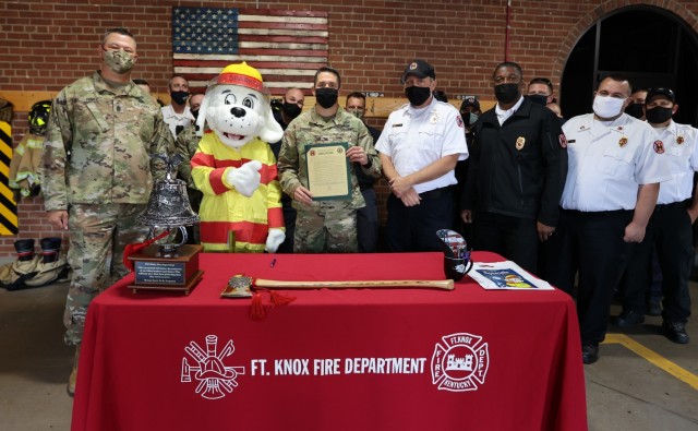 Surrounded by members of the Fort Knox Fire Department, Fort Knox Garrison Commander Col. Lance O’Bryan signs the annual Fire Prevention Proclamation Sept. 27, 2021 at Fire Station No. 1.