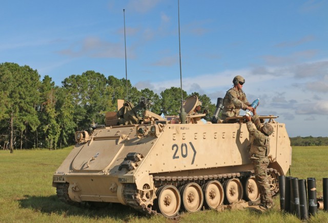 A Soldier assigned to the mortar section of 3rd Battalion, 67th Armored Regiment, 2nd Armored Brigade Combat Team, 3rd Infantry Division, hands off a 120mm round to his assistant gunner at OP4 on Fort Stewart, Georgia, Sept. 15, 2021. The mortar...