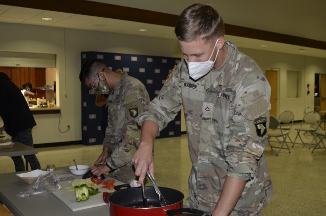 Private Anthony Ocana and Pfc. Nicholas Wagner, Kalsu Replacement Company, work together on a homecooked meal Sept. 9 during the inaugural “Cookin’ in the Bs” class hosted at USO Fort Campbell.