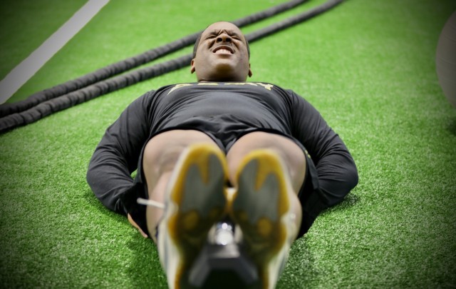 Army Reserve Sgt. Demos Moore, a chemical, biological, radiological and nuclear specialist assigned to the 377th Chemical Company, 485th Chemical Battalion, 76th Operational Response Command, performs leg lifts with a 12.5 pound weight at a gym in Richmond, Virginia, February 18.  Moore, who once struggled with being overweight and out of shape has dedicated himself to physical fitness, losing more than forty-pounds in the past four months. (Official U.S. Army Reserve photo by Sgt. 1st Class Brent C. Powell)