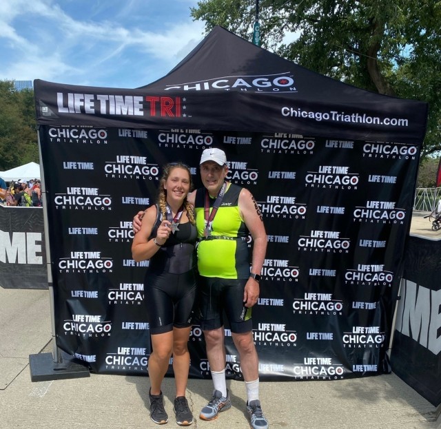 First Lt. Victoria Falk, left, the human resource officer for the "Hound Battalion," 3rd Battalion, 67th Armor Regiment, 3rd Infantry Division, poses with her father, right, after competing together at the Chicago Triathlon, in Chicago, Illinois,...