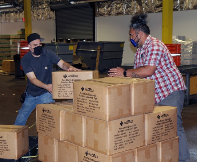 Josue Alvarado, left, and Gaosa Tautolo, right, assemble a pallet of disposable gowns as part of Sierra Army Depot's mission to supply COVID-19 personal protective equipment support to Operation Allies Welcome. Sierra Army Depot, located in Herlog, California -- approximately 60 miles north of Reno, Nevada -- is suppling COVID-19 PPE to eight different U.S. Department of Defense installations that are supporting the mission providing temporary housing, sustainment and support inside the United States for Afghan personnel. The Department of Defense, in support of the Department of State, is providing transportation and temporary housing in support of Operation Allies Refuge. This initiative follows through on America's commitment to Afghan citizens who have helped the United States, and provides them essential support at secure locations outside Afghanistan.