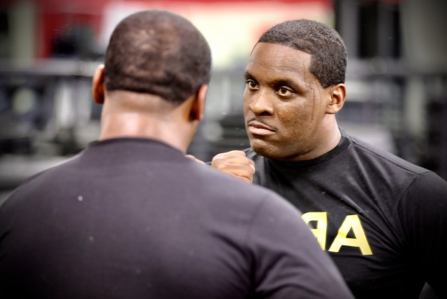Army Reserve Sgt. Demos Moore, a chemical, biological, radiological and nuclear specialist assigned to the 377th Chemical Company, 485th Chemical Battalion, 76th Operational Response Command, checks out his reflection in a mirror after working out at a gym in Richmond, Virginia, February 18. Moore, who once struggled with being overweight and out of shape has dedicated himself to physical fitness, losing more than forty-pounds in the past four months. (Official U.S. Army Reserve photo by Sgt. 1st Class Brent C. Powell)
