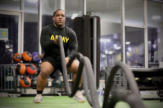 Army Reserve Sgt. Demos Moore, a chemical, biological, radiological and nuclear specialist assigned to the 377th Chemical Company, 485th Chemical Battalion, 76th Operational Response Command, works out with rope lines at a gym in Richmond,...