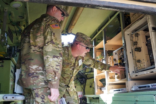 First Lt. Thomas J. Allen assigned to  “Spartan Brigade,” 2nd Armored Brigade Combat Team, 3rd Infantry Division, shows a fellow leader the new features of one concept of employment for the Army’s high-profile network communication pilot effort known as ABCT On-the-Move, or OTM, during a distinguished visitors day at the General Dynamics facility in Taunton, Massachusetts, Sept. 21, 2021. During the demonstration, General Dynamics Mission Systems displayed three different concepts of employment that the Spartan Brigade will assess during the Army’s pilot late winter in 2022 at Fort Stewart. (U.S. Army photo by Amy Walker, PM Tactical Network, PEO C3T)