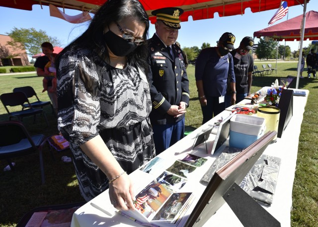Attendees at the Gold Star families recognition event look through photographs, newspaper clippings, award citations and other memorabilia set up by the family of Air Force Staff Sgt. Joshua Schoenhoff, an instrument and flight control systems specialist – and Bourbon, Missouri, native – who died trying to save a fellow Airman during a 2014 typhoon in Okinawa, Japan. The event Sept. 25 on the Maneuver Support Center of Excellence Plaza was organized by Army Community Services’ Survivor Outreach Services office, which invites Gold Star families to Fort Leonard Wood each year as a way to celebrate the lives of their loved ones while assisting in the healing process.